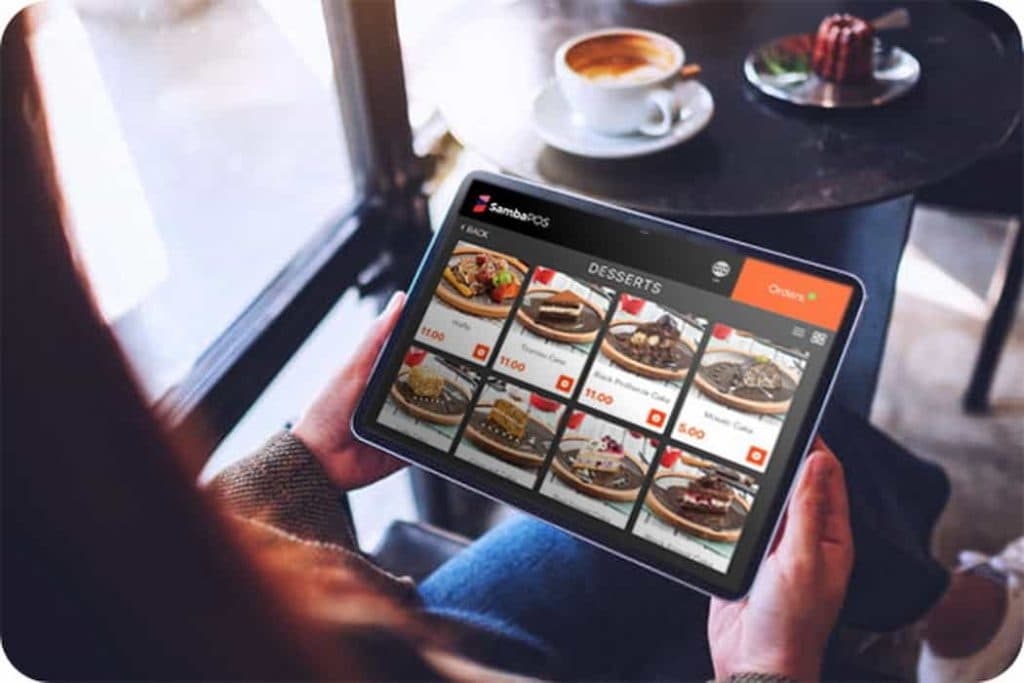 A restaurant host station with a tablet showing an online reservation system, representing the digital booking tools most often targeted in ADA website accessibility lawsuits